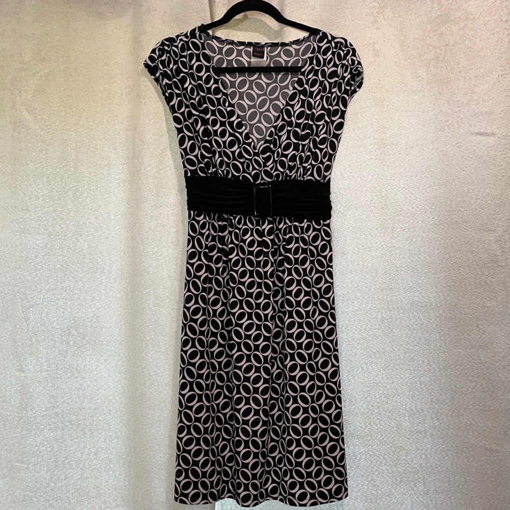 Black & white dress. Buckle in front. Ties in back